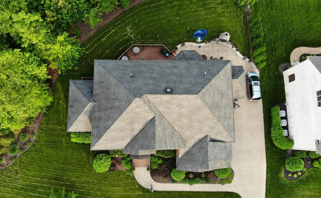 An aerial view of a property surrounded by greenery 