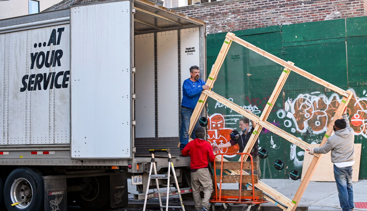 A moving truck being loaded by movers