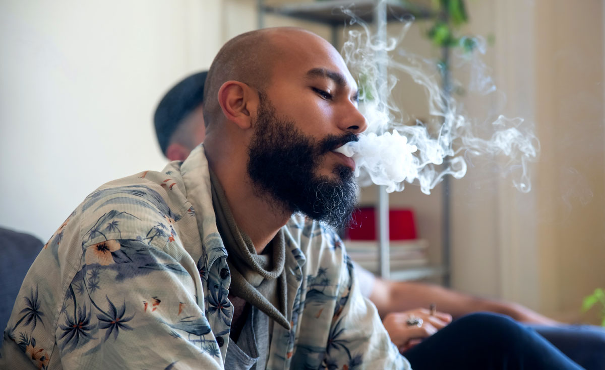 A Man Exhaling Smoke from Mouth