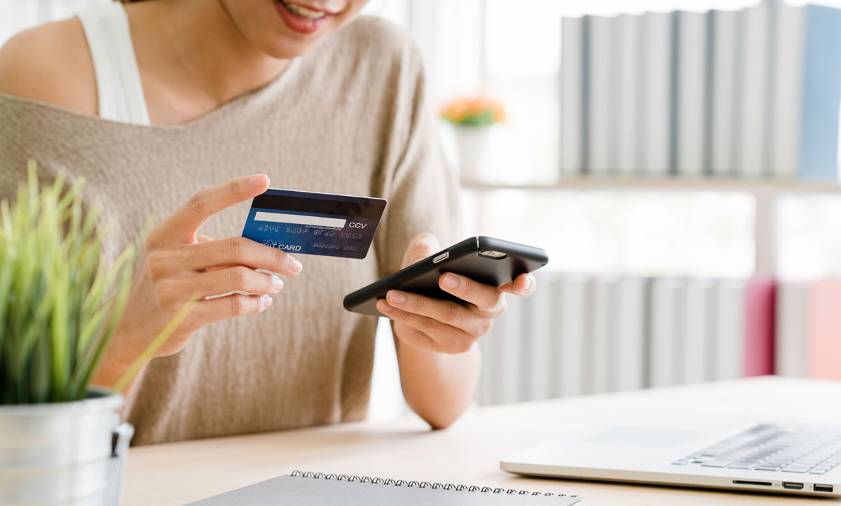 woman using smartphone paying online