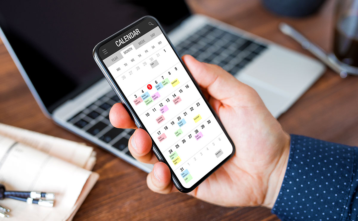 Man using calendar app on mobile phone
