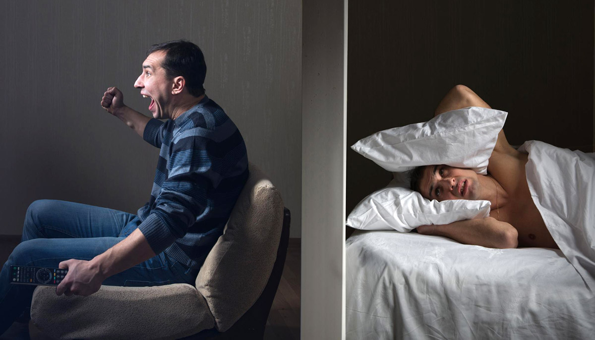 Man at night can't fall asleep because of the noisy neighbor