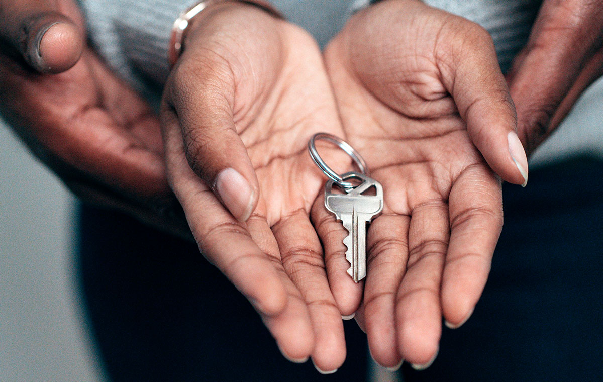 A person holding a key in their hands