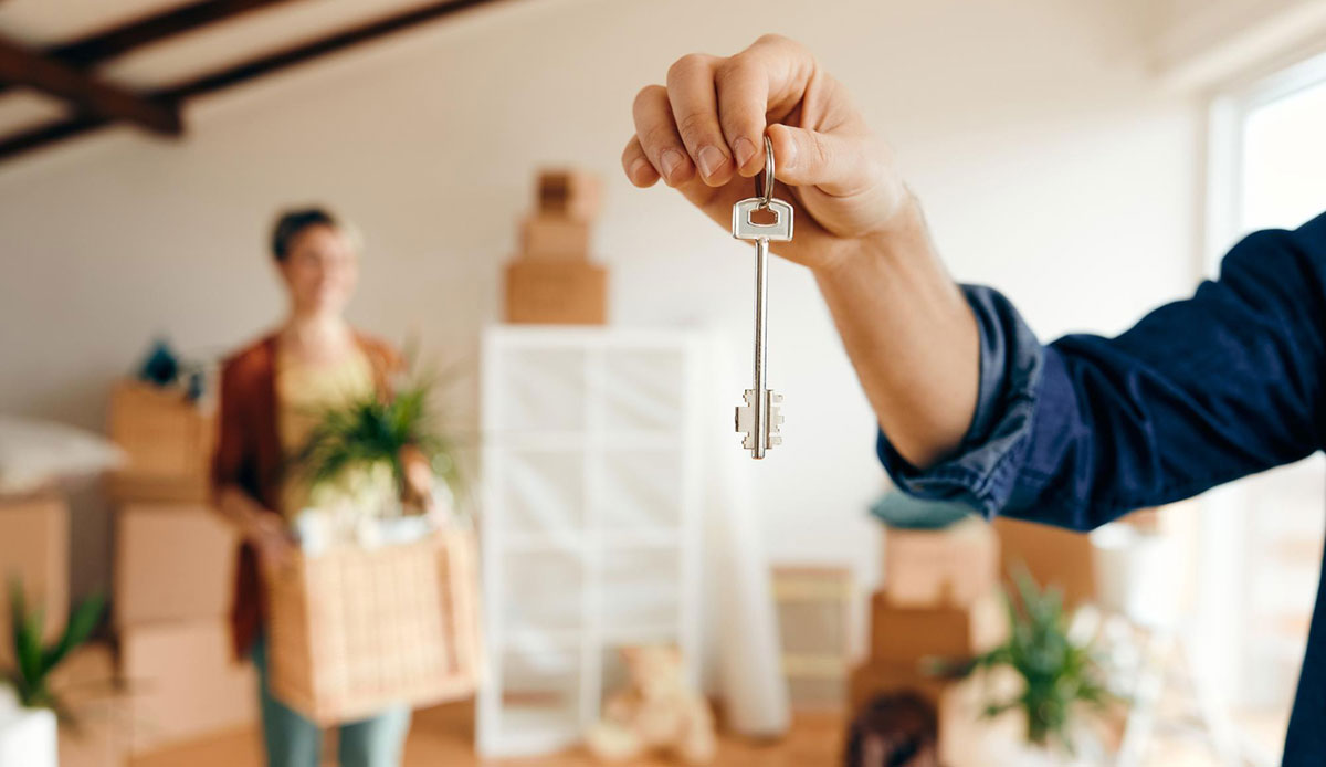 A man holding the key to his rental property.