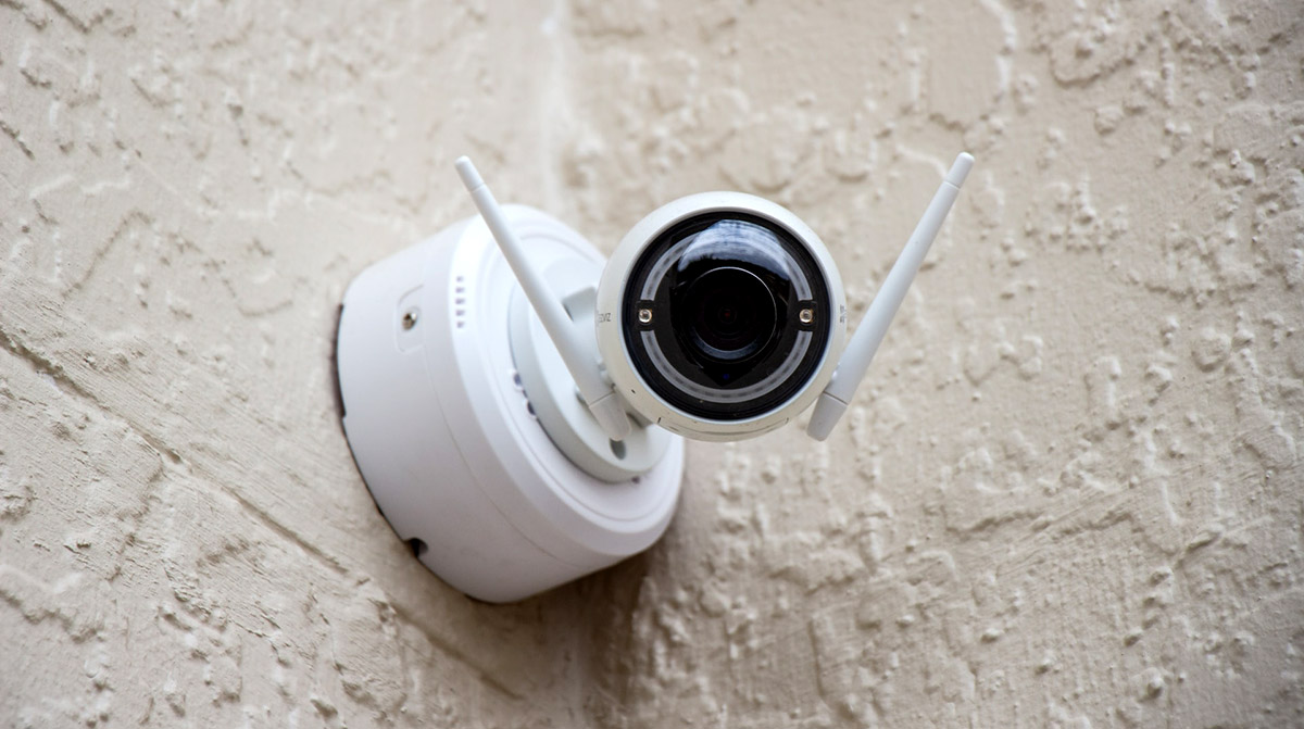 A white camera linked to a security system