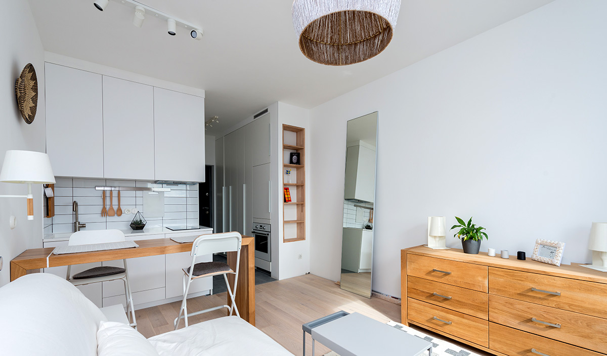 a minimalist design of a contemporary apartment with white and wooden furniture