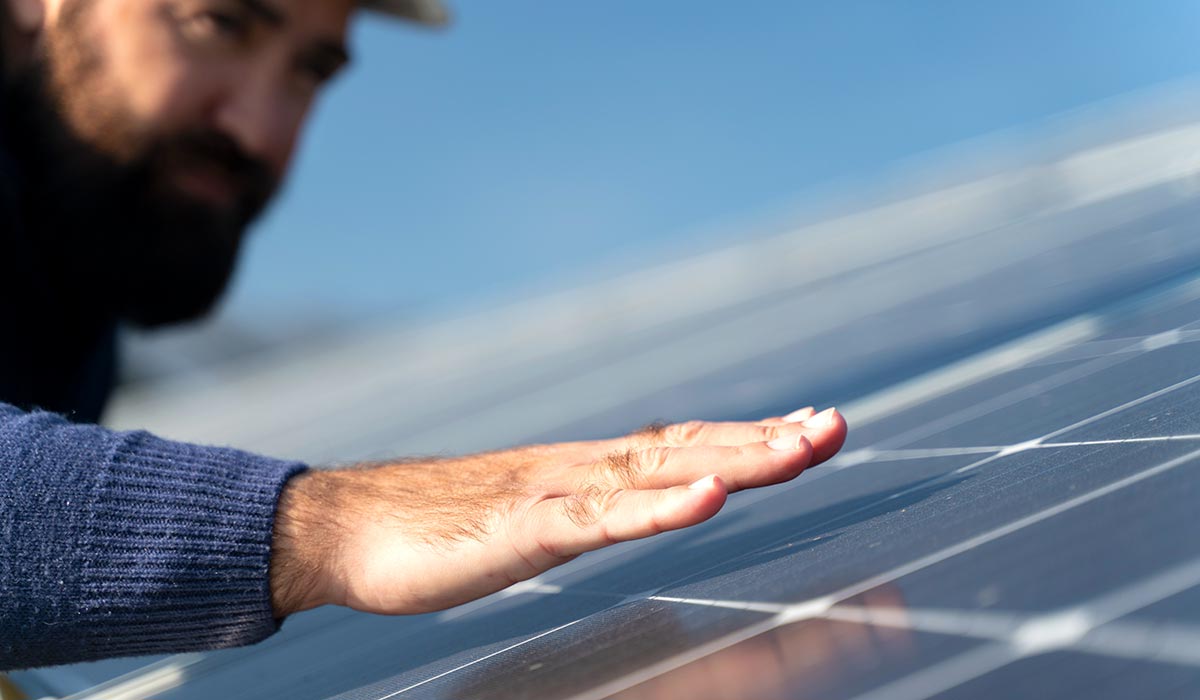 Person cheking solar panel
