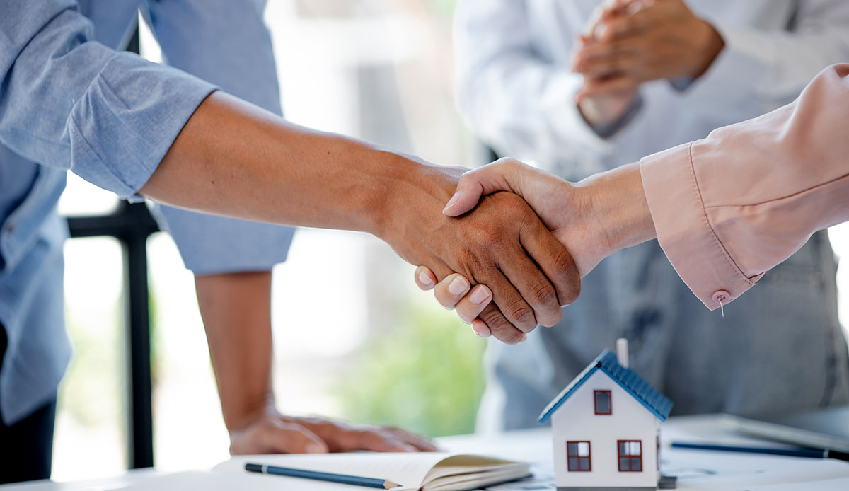 Rental owners shake hands with the new tenant