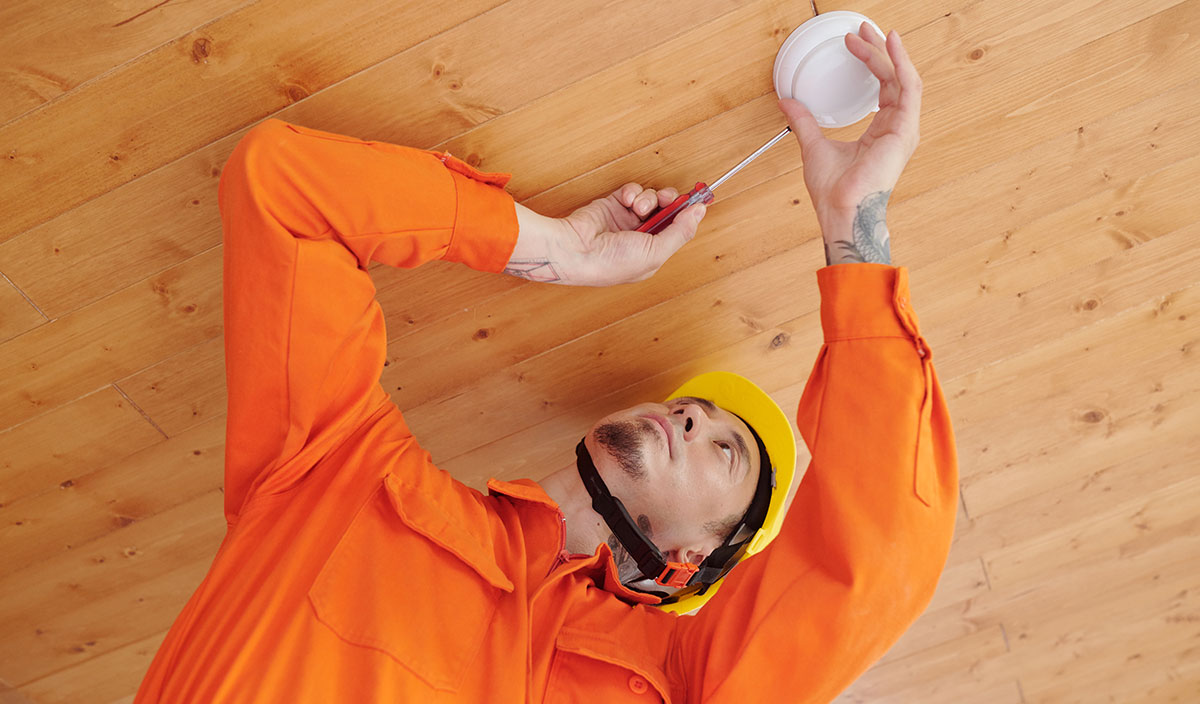 Technician Installing Smoke Detector