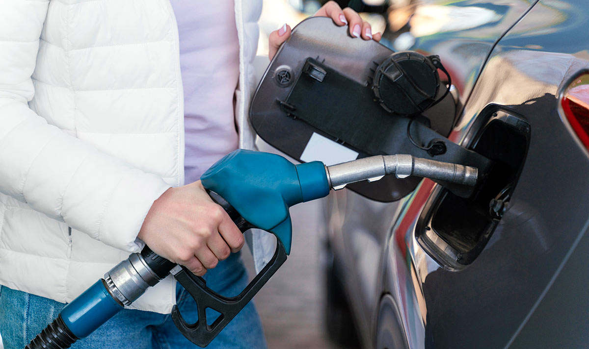 Woman filling up the car at the gas station