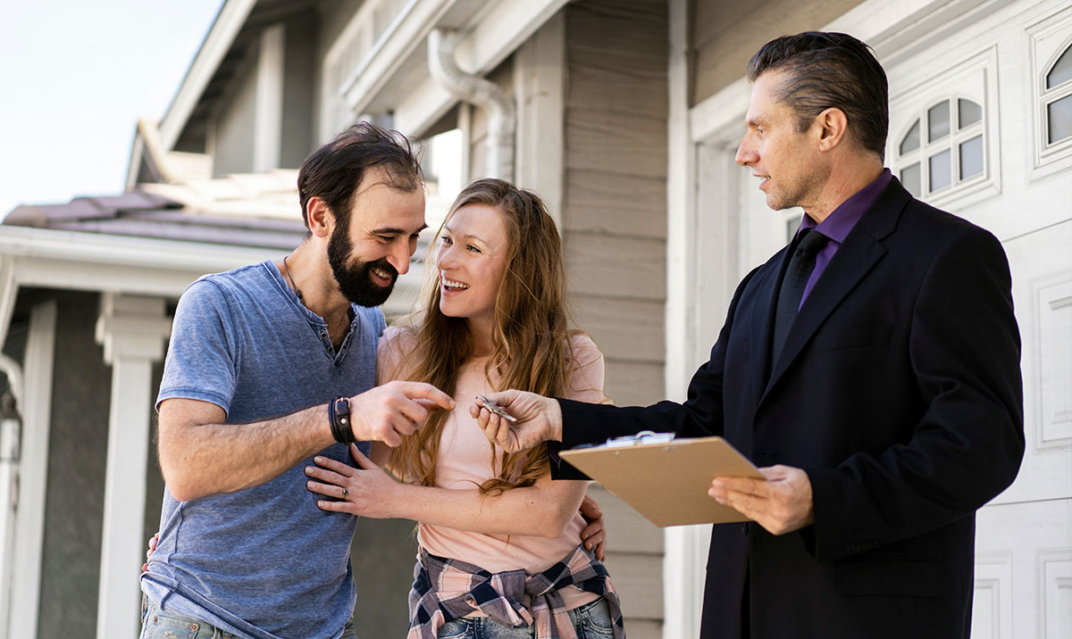 Couple signing papers for new house