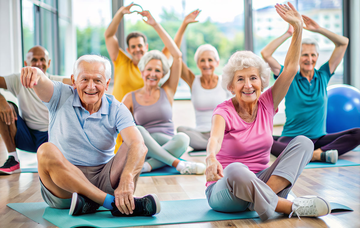 Group of Senior Adults Enjoying a Yoga Class in a Bright Modern Fitness Studio with Large Windows and Natural Light