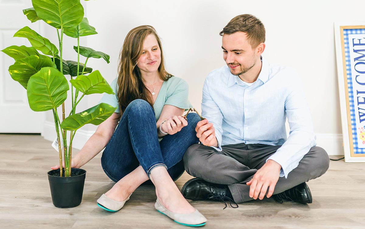 A couple sitting on a floor