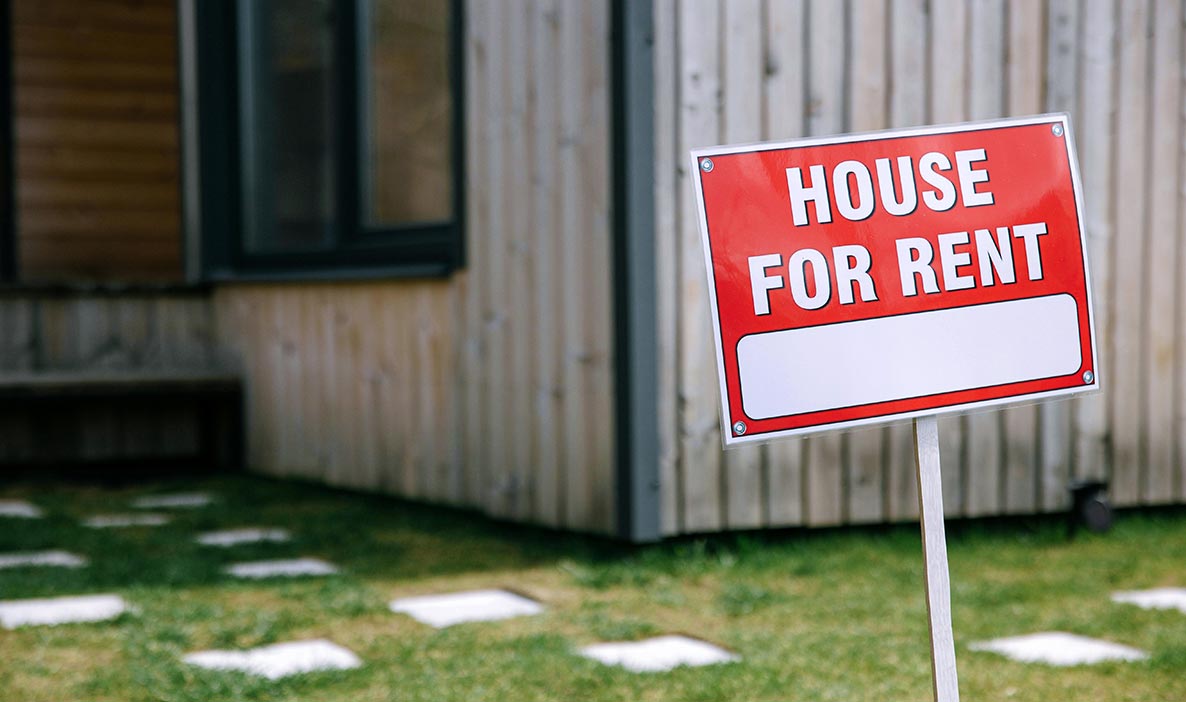 Red and White For Rent Signage Near the Wooden House