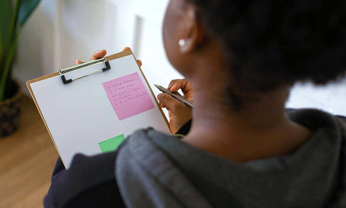 A woman holding a pen and a clipboard