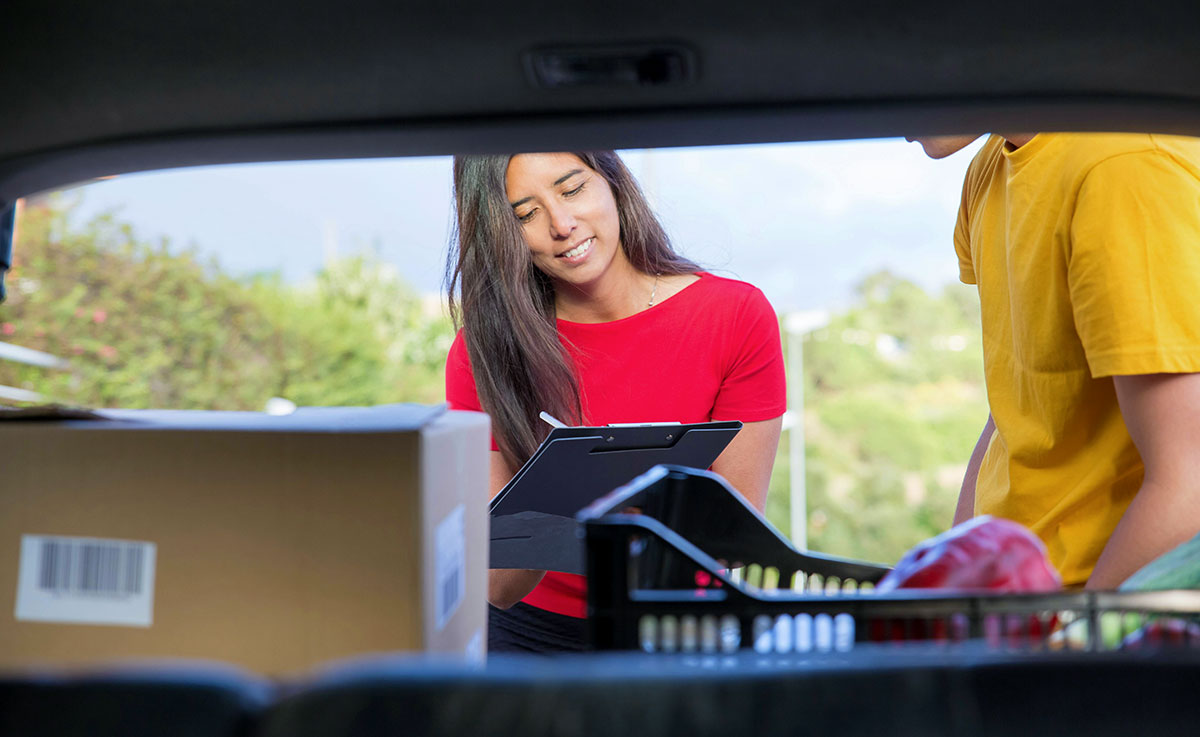 A couple checking their things in a car trunk