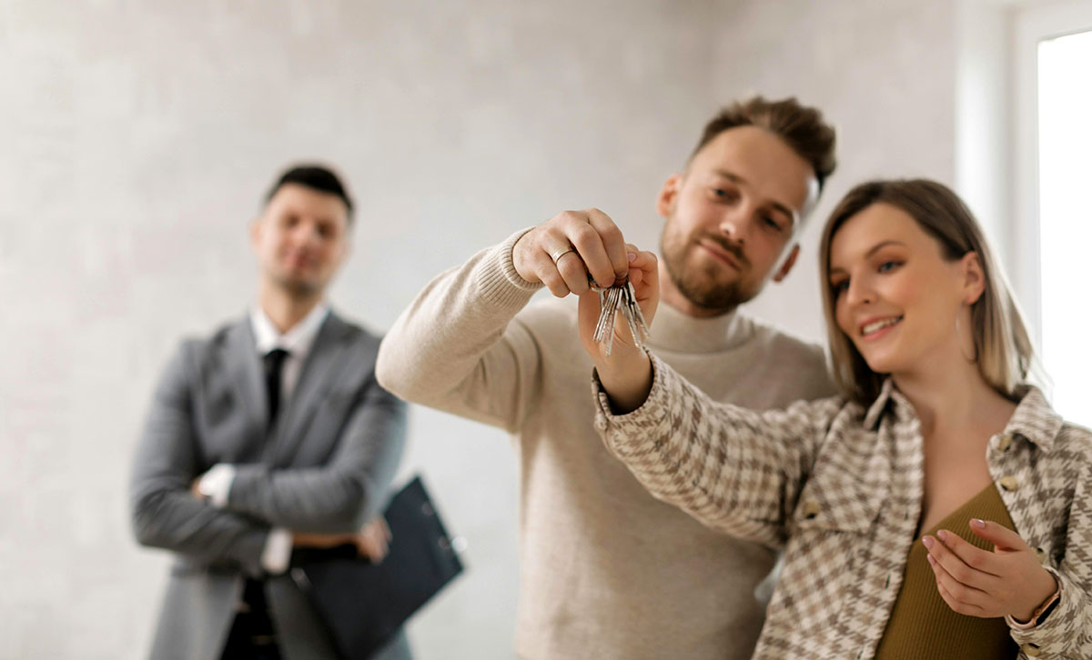 A couple holding a key to their new home