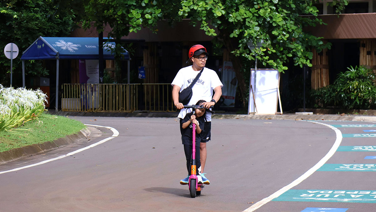 Father and child riding a scooter