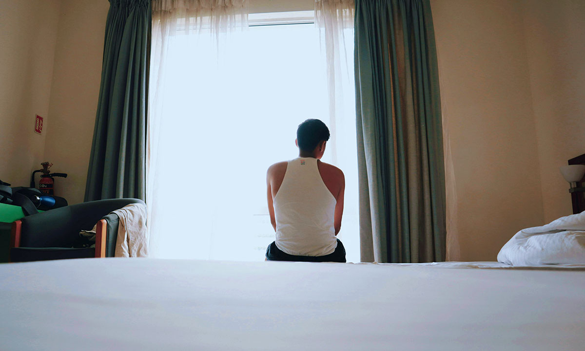 man sitting on the bed